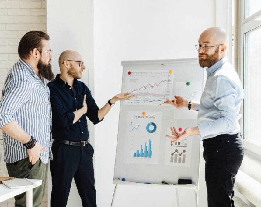 photo of people looking at charts