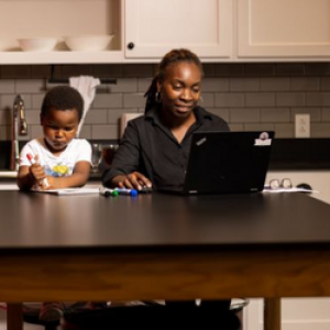 mother working in kitchen with child working beside her