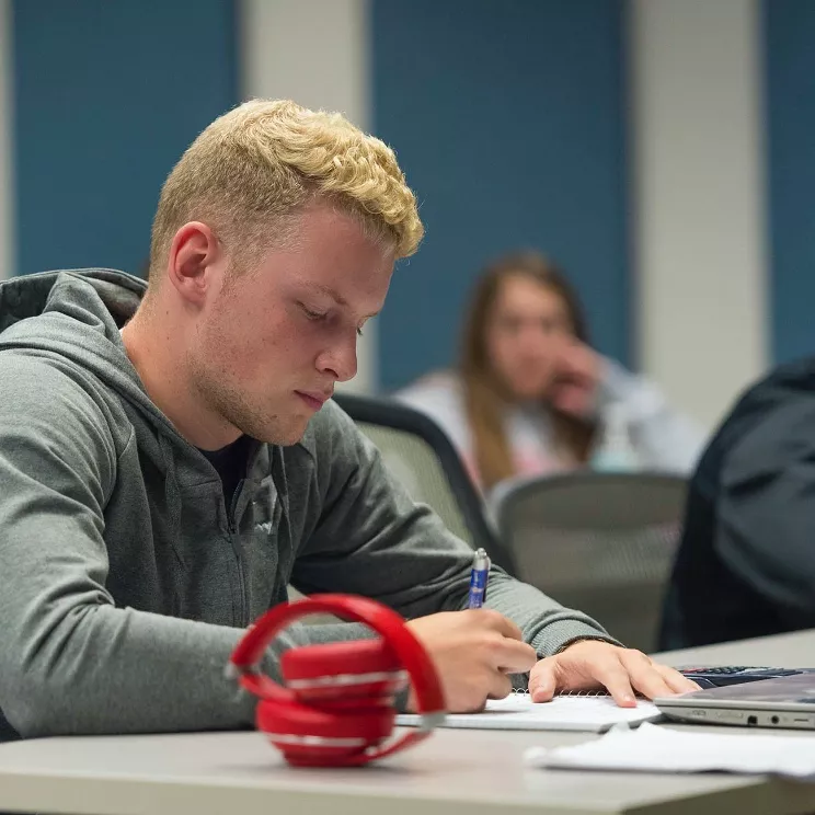 A Student with red headphones
