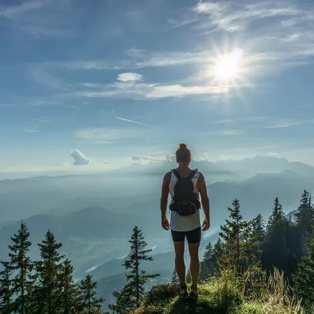 girl with a backpack on top of a mountain