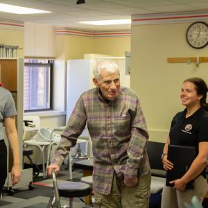 OT and PT students welcome a patient to the clinic