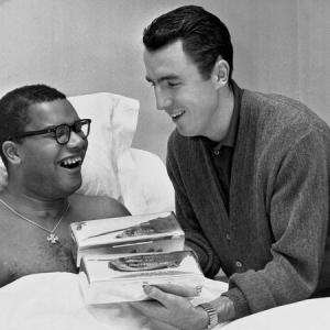 Jack Twyman showing a book to Maurice Stokes