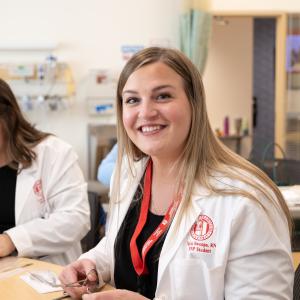 A FNP Student smiles at the camera
