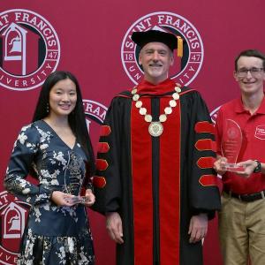 Kaylin Rose, Fr. Malachi Van Tassell, and Matthew Hall at Awards Ceremony