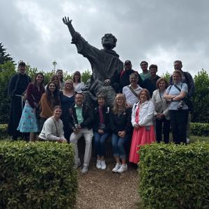 Pilgrimage group with st francis and wolf statue