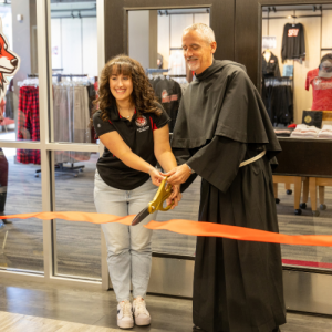 Fr. Malachi and Abrielle Brown cut the ribbon