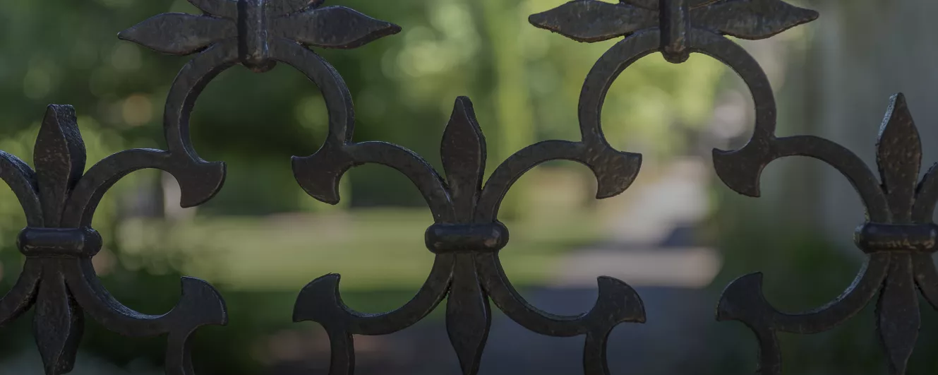 close up image of iron gates into gardens