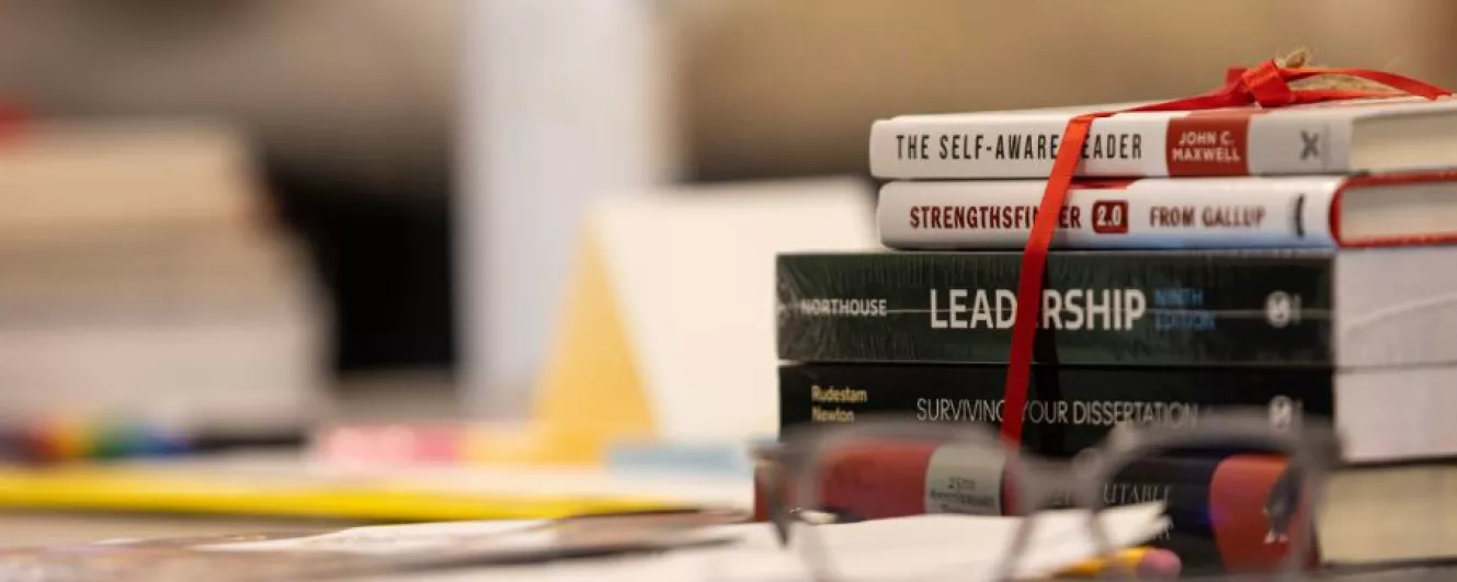 stack of books with faded background