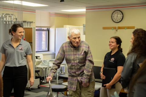 OT and PT students welcome a patient to the clinic