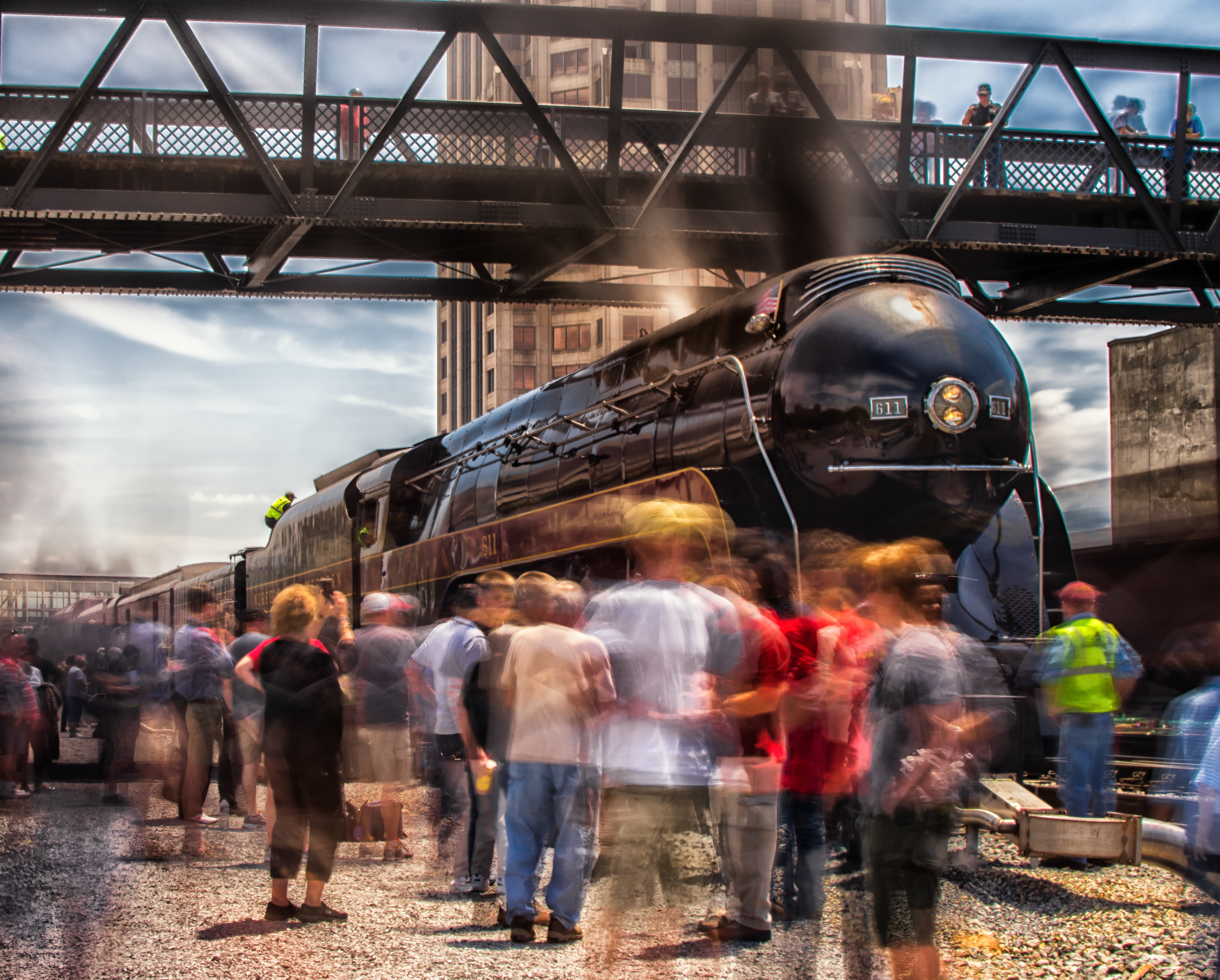 A crowd views a vintage locomotive