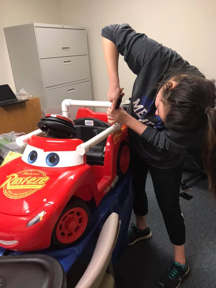 Pediatric Physical Therapy Resident, Hannah Walton assembles a GoBabyGo car